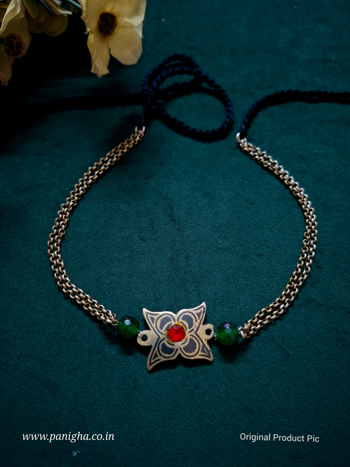 Hazara Gul minimal heritage-inspired choker with floral metal pendant, red centre stone and green glass beads by Panigha.