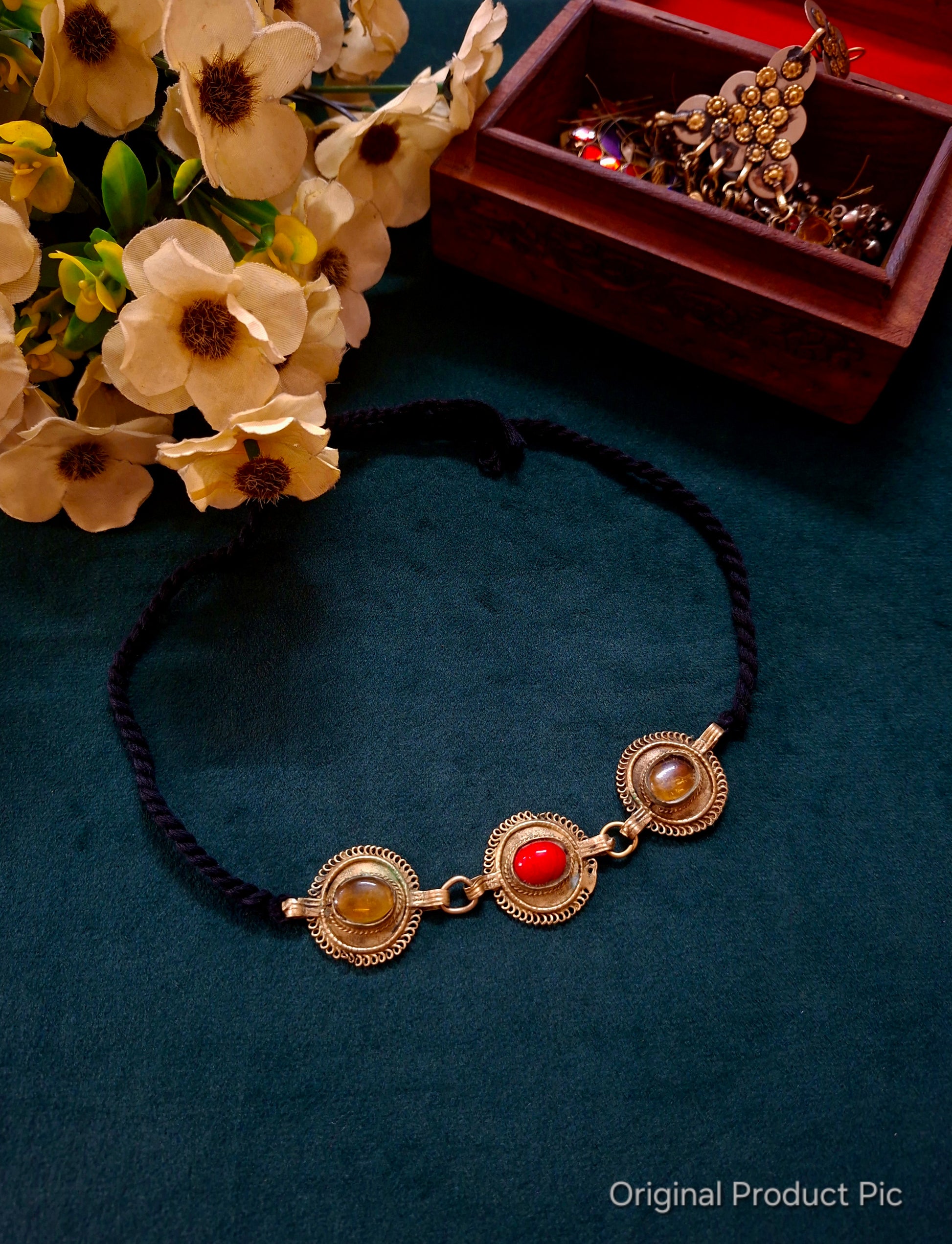 Lightweight Afghan choker with red and amber cabochon stones on a braided black cord. Vintage tribal statement jewellery curated by Panigha India.